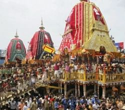 Devotees perform the traditional dance around the chariots on the occasion of Lord Jagannath Rath Yatra in Puri on Wednesday. PTI