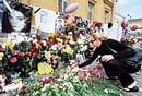 Adieu:  A  woman lays a small toy in memory of late pop star Michael Jackson at the US embassy in Moscow on Sunday. AFP
