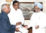 M S Liberhan, Chairman of the Commission submits report to PM Manmohan Singh as Home Minister P Chidambaram looks on in New Delhi on Tuesday. PTI