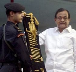 Union Home Minister P Chidambaram hands over scroll declaring operationalisation of NSG hub to NSG Commando Siddarth Thomar, in Mumbai on Tuesday. PTI