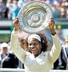 The champ: Serena Williams displays the spoils after defeating sister Venus in the Wimbledon final on Saturday. AFP