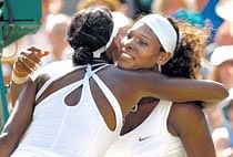 All in the family: Serena Williams is congratulated by sister Venus Williams after their singles finals at the Wimbledon in  London on Saturday. Reute
