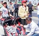Sarah Palin along with daughter Bristol, left, watch the Juneau Fourth of July parade, as husband Todd looks over son Trig and grandson.