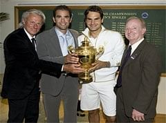 AWESOME FOUR: Roger Federer holds the Wimbledon trophy, flanked by Bjorn Borg, Pete Sampras and Rod Laver. AFP