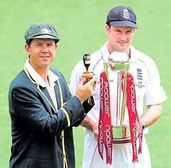 Australian skipper Ricky Ponting holds aloft a replica of the Ashes urn while his English counterpart Andrew Strauss carries the Test series trophy.