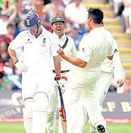 See you later!: Mitchell Johnson celebrates after getting rid of England captain Andrew Strauss on Wednesday. AP