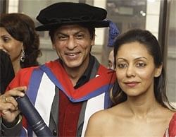 Shahrukh Khan stands alongside his wife Gauri after being given honorary doctorate  from the University of Bedfordshire, London, Friday. AP