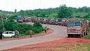 Trucks carrying iron ore parked on the National Highway at Kundapur. DH PHOTO