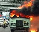 Youth Congress activists torch a bus during their road blockade on Howrah Bridge in Kolkata on Thursday. PTI