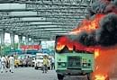 city at ransom: Youth Congress activists burn a bus during their road blockade on Howrah Bridge in Kolkata on Thursday. pti