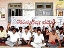 DSS activists staging dharna in front of the taluk panchayat office in Mulbagal on Friday, DH Photo