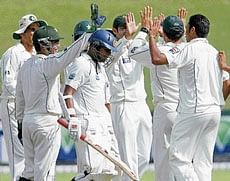 CELEBRATION TIME: Pakistani players celebrate the dismissal of Sri Lankas Malinda Warnapura on Thursday. Reuters