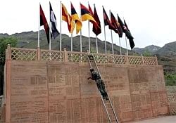 An army solider gives final touch to Kargil war memorial in the backdrop of recaptured post of Tololing in Drass on Friday. PTI