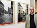 Stefen Koppelkamm stands next to his photographs.