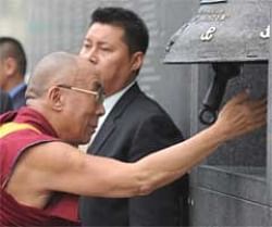 Dalai Lama rings a bell at a museum in Warsaw dedicated to the ill-fated 1944 Warsaw uprising against the Nazis. AFP