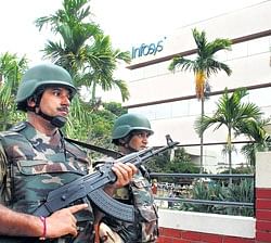Central Industrial Security Force (CISF) personnel stand guard after being deployed at Infosys Technologies headquarters in Bangalore on Friday. PTI