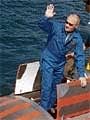 Vladimir Putin gestures as he enters a hatch on a mini-submarine in Lake Baikal on Saturday. AP