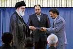 Irans supreme leader Ayatollah Ali Khamenei (L) presents a decree to Iranian Prez Mahmoud Ahmadinejad during an official ceremony in Tehran, Monday.