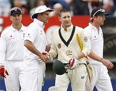 Australia's Michael Clarke, centre right, shakes hands with England's Andrew Strauss after their team's draw . AP