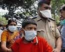 Children along with their parents wait outside Naidu Hospital to test for H1N1 virus in Pune on Wednesday. PTI