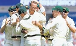 Paceman Stuart Clark is mobbed by his team-mates after accounting for Alastair Cook on day one of the fourth Test on Friday. AP