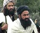Undated photo from 2004 shows Pakistani Taliban chief Baitullah Mehsud (R) escorted by his guard. AFP