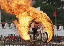 An Indian army soldier drives through a burning ring during a function to mark India's 62nd Independence Day in Bangalore on Saturday. AP