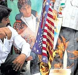 Raging protest:  Congress activists burn a US flag during a protest in Allahabad on Sunday. Reuters
