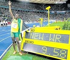 Jamaican Usain Bolt proudly poses next to the screen announcing a new world record in the mens 100 metres. AP