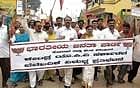 UP IN ARMS Members of BJP district unit taking out a protest march condemning rise in the price of essential commodities in Kolar on Monday. DH Photo