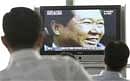 South Koreans watch a TV broadcasting a report about South Korean former President Kim Dae-jung's death at the Yosu Airport. AP