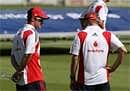 England's Andrew Strauss, left, speaks to coach Andy Flower during practice at the Oval, on Tuesday. AP.