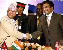 Nepal Prime Minister Madhav Kumar Nepal shakes hands with Assocham Vice President Dilip Modi at a Business Meeting in New Delhi on Wednesday. PTI