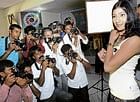 shutterbugs Lensmen snapping a model at the World Photographers Day function in Bangalore on Wednesday. DH photo