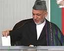 Afghan presidential candidate and current President Hamid Karzai casts his vote at a polling station in Kabul on Thursday. AP