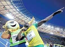 Jamaican Usain Bolt celebrates with mascot Berlino after winning the 200M gold at the World Athletics Championships on Thursday. Reuters