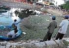 CLEAN UP ACT: Civic workers cleaning Venugopalaswamy pond for immersion of Ganesha idols in Kolar, on Friday. dh photo