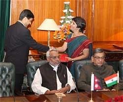 Foreign Secy Nirupama Rao exchanges documents with her Nepalese counterpart Gyan Chandra Acharya during signing of Indo-Nepal agreement ceremony. PTI