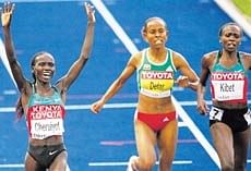 NUMBER UNO: Kenya's Vivian Cheruiyot (left) celebrates after winning the women's 5000M gold at the World Athletics Championships in Berlin on Saturday
