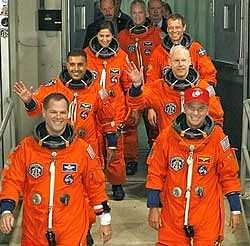 Crew members of space shuttle Discovery leave the Operations and Checkout Building on Monday night. AP