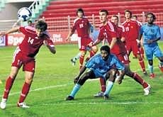 SCORING CHANCE: Kyrgyzstan players (in red) attempt to score against Sri Lanka in a Nehru Cup match on Friday. PTI