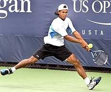 Somdev Devvarman returns a backhand to Jerzy Janowicz of Poland at the US Open Men's qualifying singles match at Flushing Meadows in New York. PTI