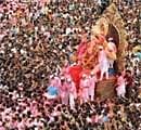 Huge idol of Lord Ganesha being taken by devotees through a busy throughfare for immersion in the Arabian sea in Mumbai on Thursday. AFP
