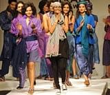 Indian models introduce Bangladeshi designer Bibi Russell (C) on the runway during the Kolkata Fashion Week in Kolkata