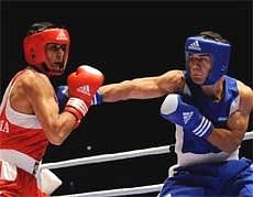 India's Vijender Kumar (L), fights against Abbos Atoev, of Uzbekistan, during a men's middleweight 75 kg semifinal boxing match at the World Champions