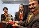A temple official (R), presents a replica of the Pashupatinath temple to Nirupama Rao (L), Indian ambassador to Nepal Rakesh Sood (C) also seen. AP