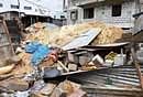 A wall collapsed at the workers shed at Kammasandra, Hebbagudi in Bangalore on Wednesday. DH Photos