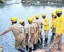Emergency services personnel conducting search operations at Madiwala lake in Bangalore on Thursday.  DH Photo