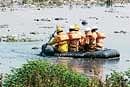 Fire personnel searching for the missing boy at Madivala lake for the third day. DH PHOTO