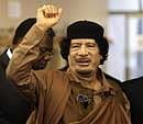 Libyan leader Muammar Gaddafi gestures as he enters the U.N. headquarters for the United Nations General Assembly on Wednesday. AFP